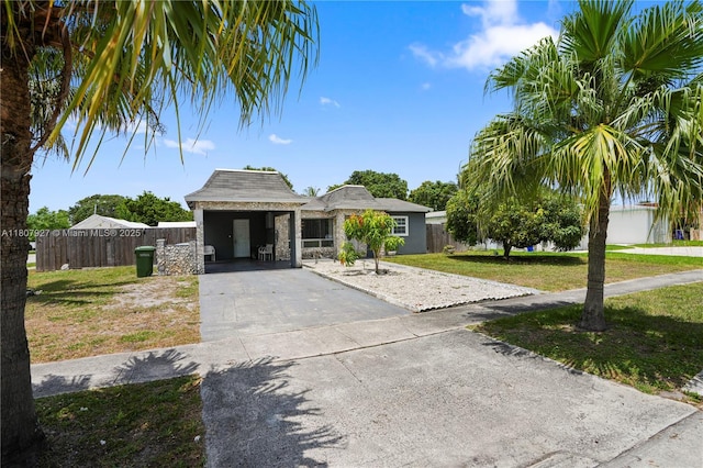 5390 SW 10th Ct, Margate, FL 33068 - view of front facade with asphalt driveway, a carport, and stone siding