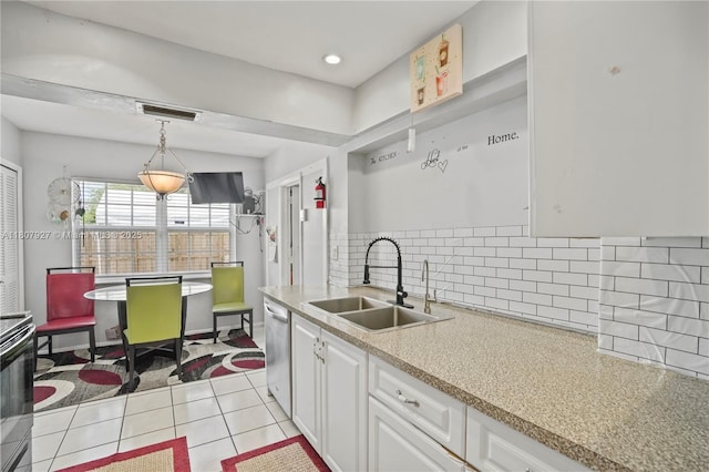 5390 SW 10th Ct, Margate, FL 33068 - kitchen featuring a sink, stainless steel dishwasher, white cabinetry, light countertops, and decorative backsplash