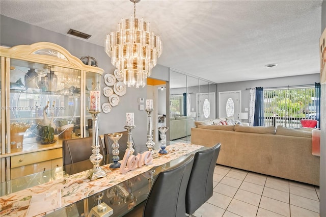 5390 SW 10th Ct, Margate, FL 33068 - dining space featuring tile patterned floors, a textured ceiling, and a chandelier