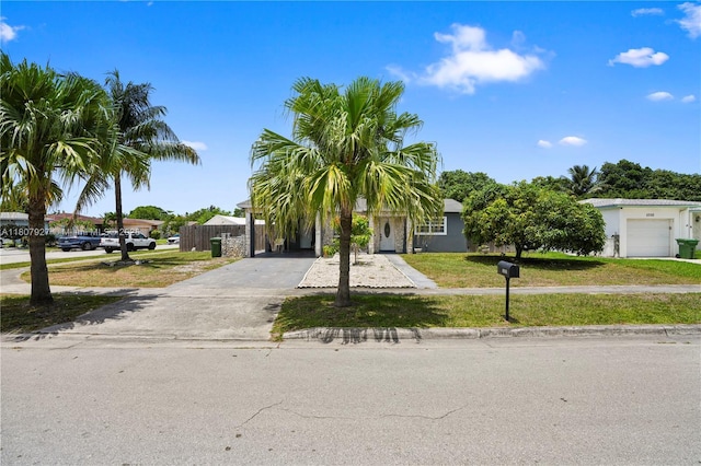 5390 SW 10th Ct, Margate, FL 33068 - view of property hidden behind natural elements with concrete driveway and a front yard