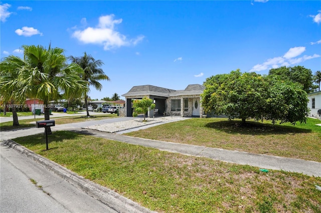 5390 SW 10th Ct, Margate, FL 33068 - view of front facade with driveway, a front lawn, and stone siding