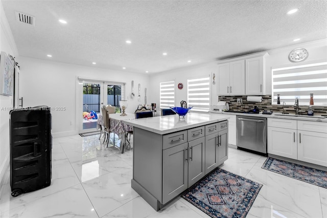 9304 SW 166th Ter, Palmetto Bay, FL 33157 - kitchen featuring dishwasher, a textured ceiling, gray cabinetry, light marble finish floors, and recessed lighting
