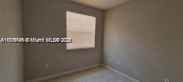 2903 SE 17th Ave Unit 102, Homestead, FL 33035 - spare room featuring baseboards