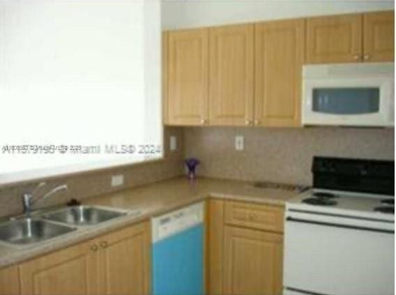 2903 SE 17th Ave Unit 102, Homestead, FL 33035 - kitchen with white appliances, a sink, light countertops, and light brown cabinetry