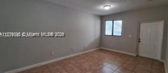 2903 SE 17th Ave Unit 102, Homestead, FL 33035 - tiled spare room with baseboards