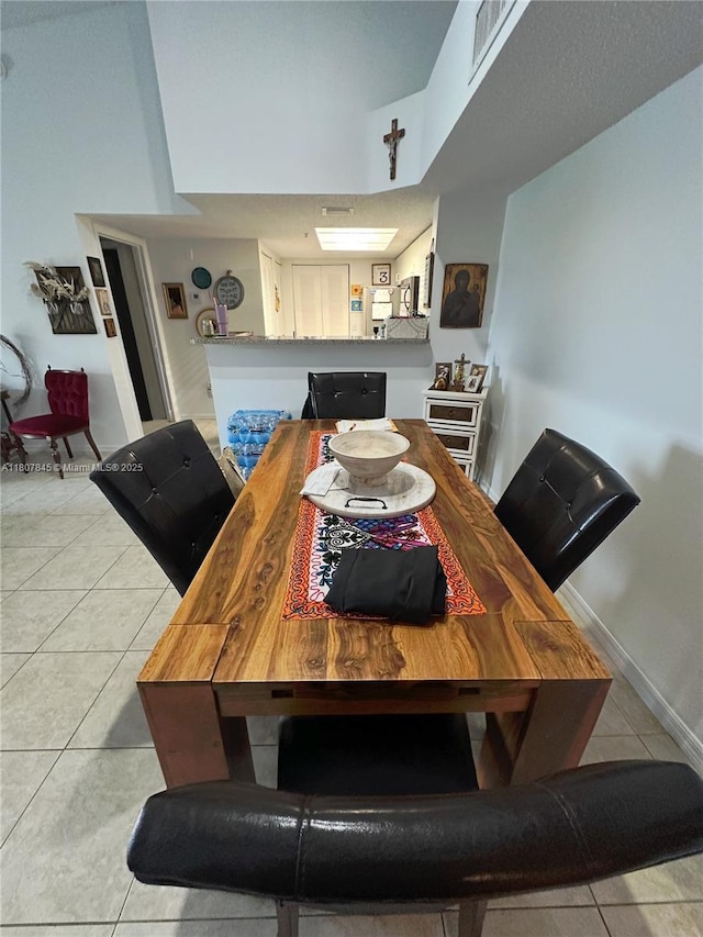 5031 Wiles Rd Unit 304, Coconut Creek, FL 33073 - dining room featuring light tile patterned floors and baseboards