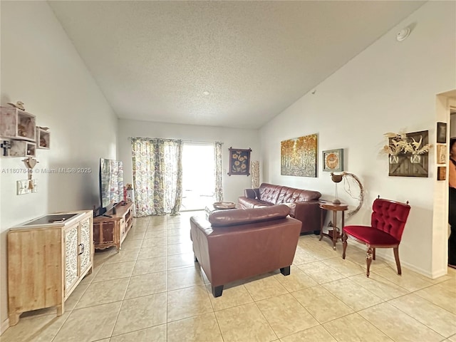 5031 Wiles Rd Unit 304, Coconut Creek, FL 33073 - living area featuring light tile patterned floors, a textured ceiling, and high vaulted ceiling