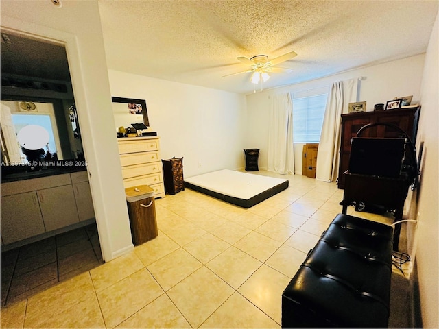 5031 Wiles Rd Unit 304, Coconut Creek, FL 33073 - bedroom with light tile patterned floors, a textured ceiling, and a ceiling fan