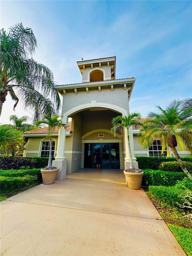 5031 Wiles Rd Unit 304, Coconut Creek, FL 33073 - view of building exterior featuring concrete driveway
