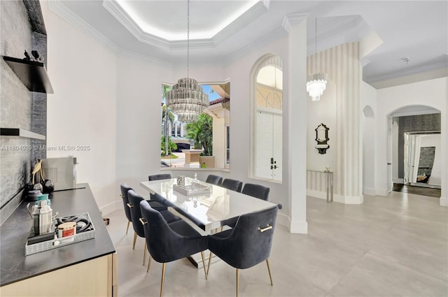 10881 Hawks Vista St, Plantation, FL 33324 - dining area featuring arched walkways, ornamental molding, a chandelier, baseboards, and a tray ceiling