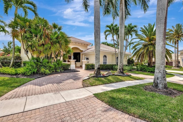10881 Hawks Vista St, Plantation, FL 33324 - mediterranean / spanish home with curved driveway, stucco siding, and a tile roof