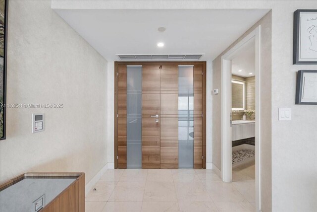 2127 Brickell Ave Unit 2302, Miami, FL 33129 - hallway with baseboards and light marble finish floors