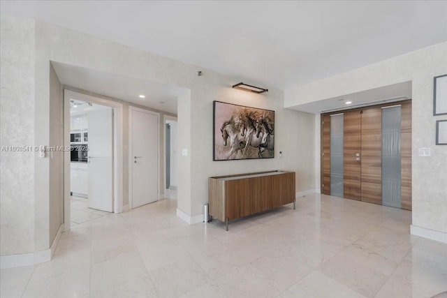 2127 Brickell Ave Unit 2302, Miami, FL 33129 - hallway with baseboards, elevator, and recessed lighting