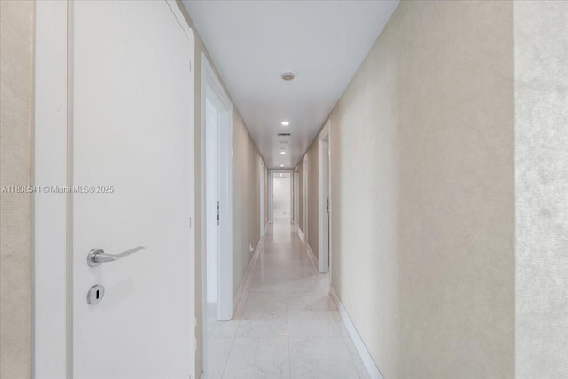 2127 Brickell Ave Unit 2302, Miami, FL 33129 - corridor featuring light marble finish floors, baseboards, and recessed lighting