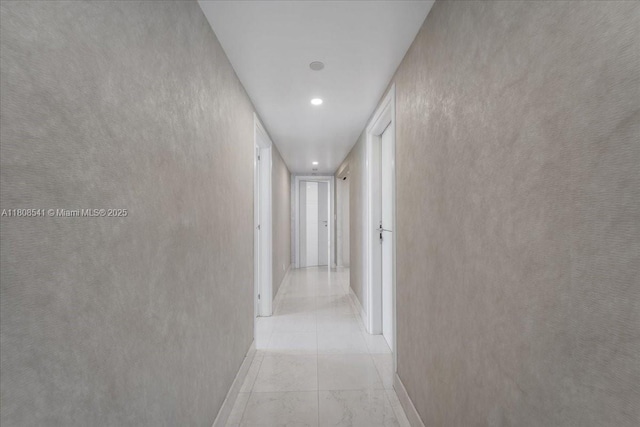 2127 Brickell Ave Unit 2302, Miami, FL 33129 - hallway with baseboards, light marble finish flooring, and recessed lighting