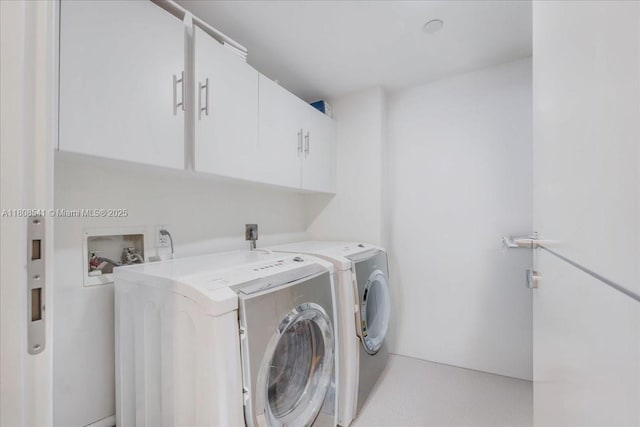 2127 Brickell Ave Unit 2302, Miami, FL 33129 - laundry room featuring cabinet space and washer and dryer