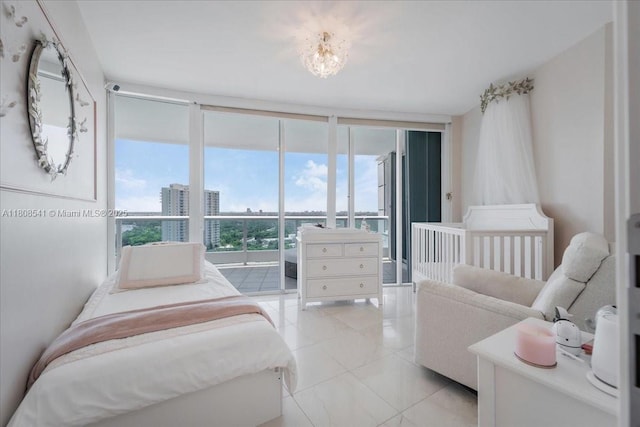 2127 Brickell Ave Unit 2302, Miami, FL 33129 - bedroom with light tile patterned floors, a city view, and expansive windows
