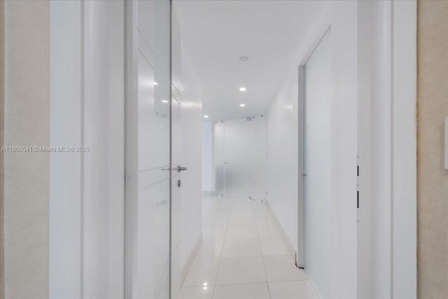 2127 Brickell Ave Unit 2302, Miami, FL 33129 - hall featuring light tile patterned floors, recessed lighting, and baseboards
