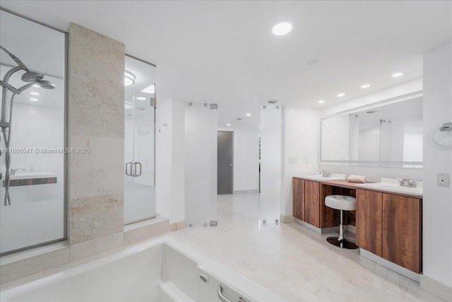 2127 Brickell Ave Unit 2302, Miami, FL 33129 - bathroom with a shower stall, double vanity, recessed lighting, and a tub