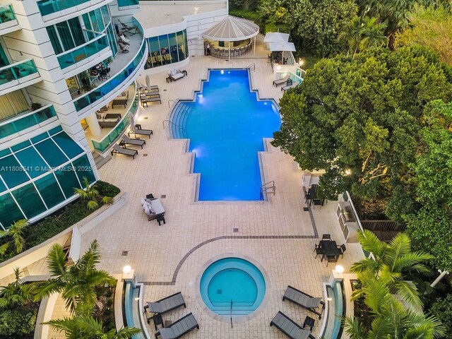 2127 Brickell Ave Unit 2302, Miami, FL 33129 - community pool featuring a hot tub, outdoor dining area, and a patio area