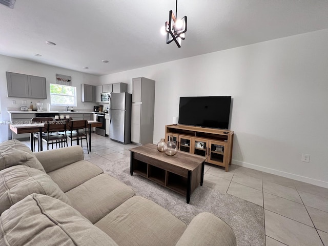 245 NE 3rd Ct, Florida City, FL 33034 - living room with light tile patterned floors, baseboards, and a chandelier