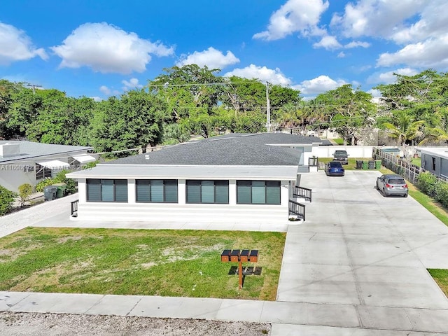 12400 NE 11th Ct, North Miami, FL 33161 - view of front facade featuring a front lawn and driveway