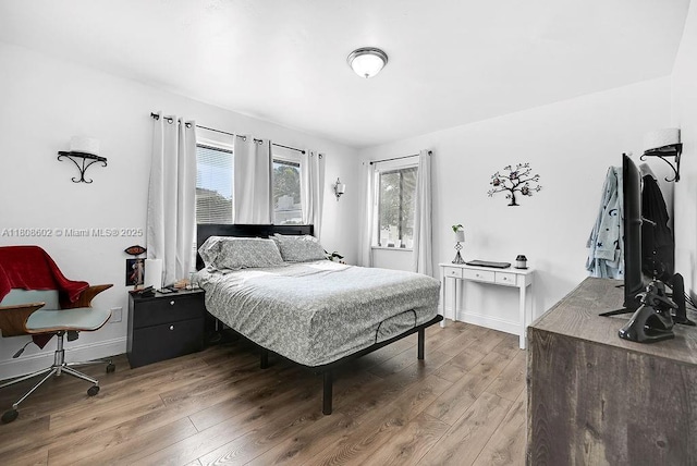 12400 NE 11th Ct, North Miami, FL 33161 - bedroom with light wood-style floors and baseboards