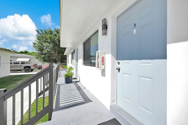 12400 NE 11th Ct, North Miami, FL 33161 - property entrance featuring a porch and stucco siding