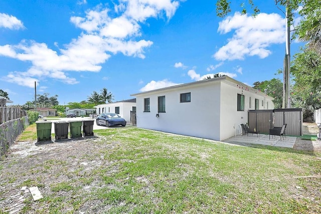 12400 NE 11th Ct, North Miami, FL 33161 - rear view of house with stucco siding and a patio