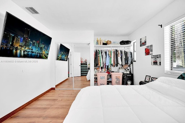 12400 NE 11th Ct, North Miami, FL 33161 - bedroom featuring wood finished floors, multiple windows, and baseboards