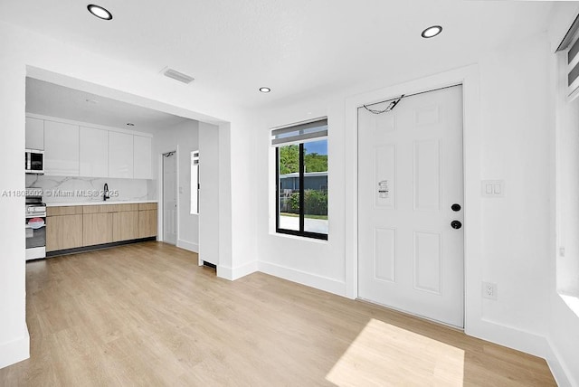 12400 NE 11th Ct, North Miami, FL 33161 - entrance foyer featuring light wood-style floors, recessed lighting, and baseboards