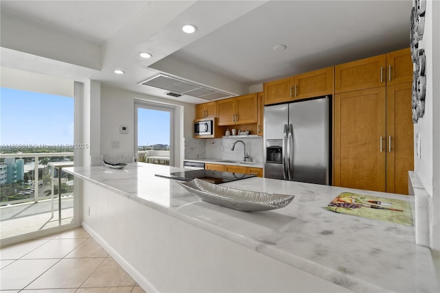 2841 N Ocean Blvd Unit 1105, Fort Lauderdale, FL 33308 - kitchen featuring appliances with stainless steel finishes, a sink, recessed lighting, light tile patterned floors, and backsplash