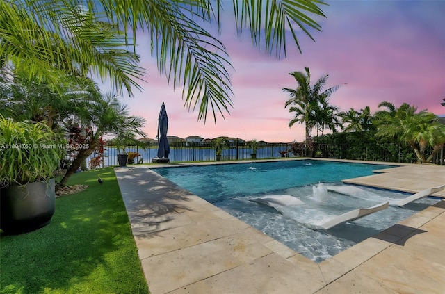 8575 Baypoint Cir, Parkland, FL 33076 - pool at dusk featuring a fenced backyard and a patio area
