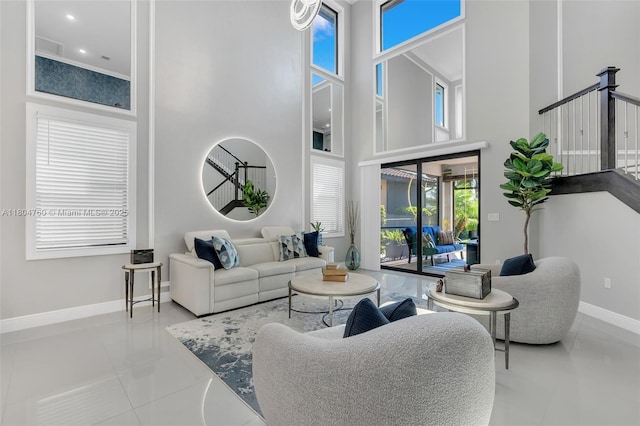 8575 Baypoint Cir, Parkland, FL 33076 - tiled living room featuring a high ceiling, baseboards, and stairway