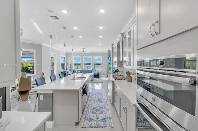 8575 Baypoint Cir, Parkland, FL 33076 - kitchen featuring double oven, ornamental molding, open floor plan, recessed lighting, and a sink