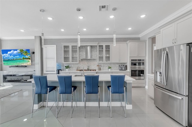 8575 Baypoint Cir, Parkland, FL 33076 - kitchen featuring appliances with stainless steel finishes, wall chimney range hood, crown molding, light countertops, and white cabinetry