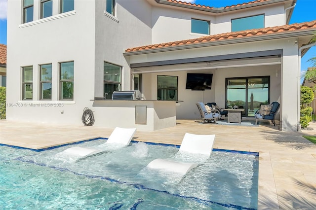 8575 Baypoint Cir, Parkland, FL 33076 - rear view of property featuring a patio area, area for grilling, stucco siding, an outdoor hangout area, and a tiled roof