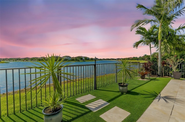 8575 Baypoint Cir, Parkland, FL 33076 - yard at dusk featuring a water view, a lawn, and a balcony
