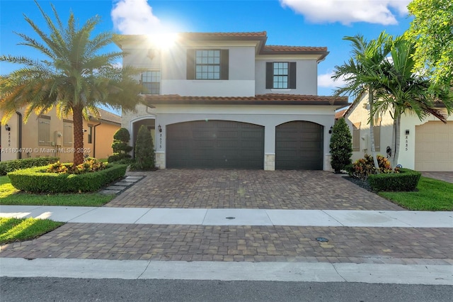 8575 Baypoint Cir, Parkland, FL 33076 - mediterranean / spanish home with stucco siding, a garage, a tile roof, and decorative driveway