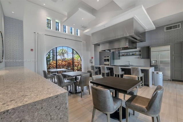 8575 Baypoint Cir, Parkland, FL 33076 - dining room with wallpapered walls and a towering ceiling