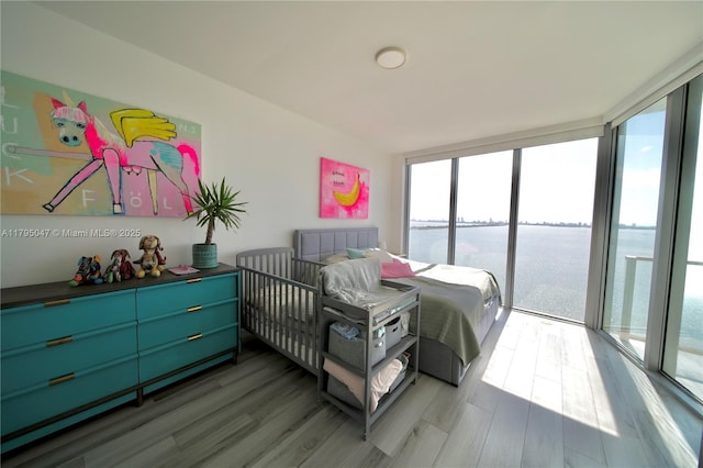 2900 NE 7th Ave Unit 1705, Miami, FL 33137 - bedroom featuring a water view, wood finished floors, access to exterior, and floor to ceiling windows