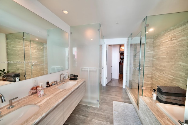 2900 NE 7th Ave Unit 1705, Miami, FL 33137 - full bathroom featuring a stall shower, double vanity, wood finished floors, a garden tub, and recessed lighting