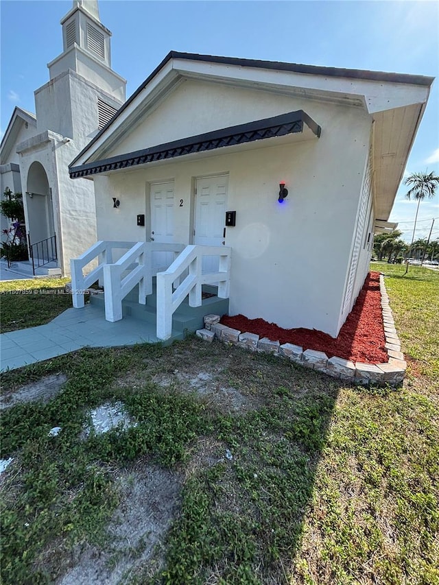 2 SW 6th Ave, Dania Beach, FL 33004 - view of front facade with stucco siding and a chimney