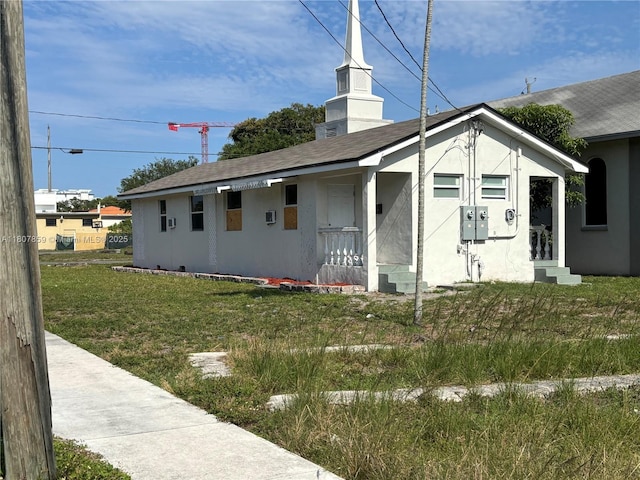 2 SW 6th Ave, Dania Beach, FL 33004 - view of side of home with a lawn, stucco siding, and roof with shingles
