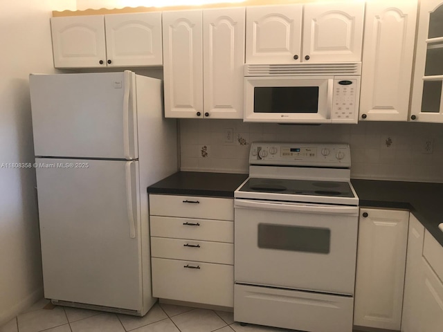 1800 SW 81st Ave Unit 1411, North Lauderdale, FL 33068 - kitchen featuring white appliances, white cabinets, dark countertops, and light tile patterned floors
