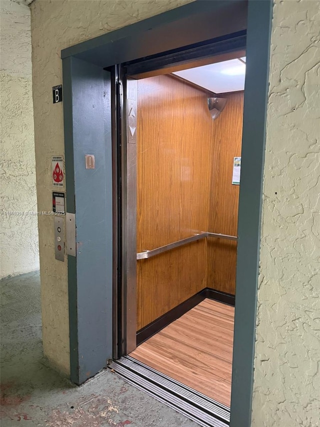 1800 SW 81st Ave Unit 1411, North Lauderdale, FL 33068 - elevator with a textured wall and wooden walls