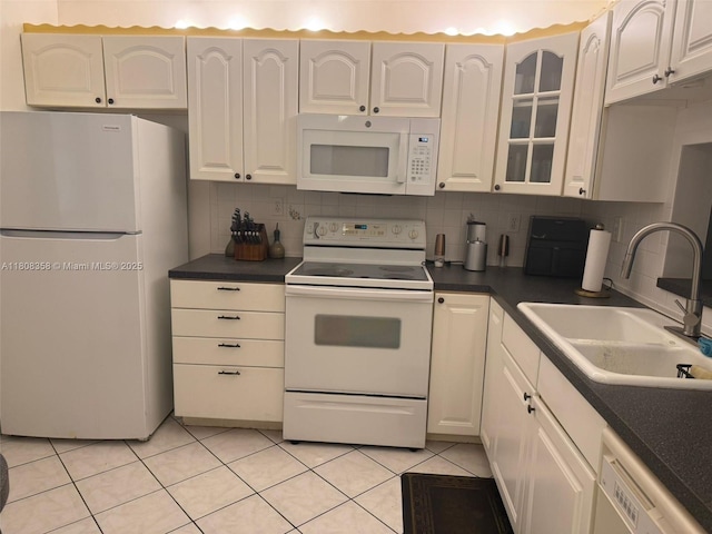 1800 SW 81st Ave Unit 1411, North Lauderdale, FL 33068 - kitchen featuring white appliances, a sink, white cabinetry, tasteful backsplash, and dark countertops