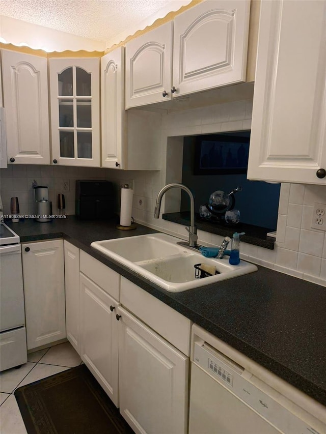 1800 SW 81st Ave Unit 1411, North Lauderdale, FL 33068 - kitchen with white appliances, tasteful backsplash, a sink, white cabinets, and a textured ceiling