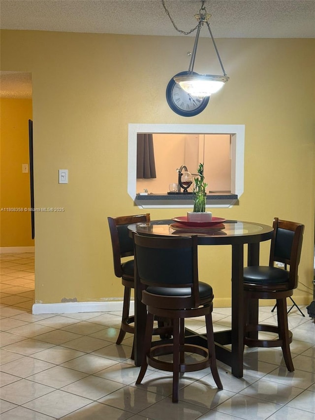 1800 SW 81st Ave Unit 1411, North Lauderdale, FL 33068 - dining room featuring a textured ceiling, light tile patterned floors, and baseboards