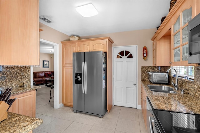 1901 SW 37th Ave, Miami, FL 33145 - kitchen featuring stainless steel appliances, light brown cabinets, a sink, decorative backsplash, and light stone counters